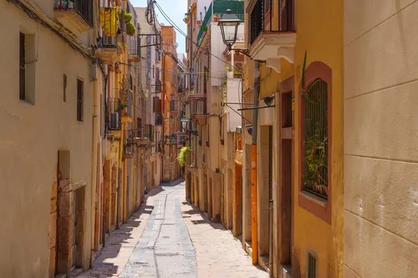 stock image Tarragona, Spain - July 14, 2024: Serene Cobbled Pathway Through Historic Tarragona Neighborhood