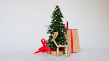 Noel ağacının, kırmızı kurdeleli hediyelerin ve 360 derecelik dönüş videosunda yakalanan ren geyiği heykelciklerinin yer aldığı minyatür bir Noel sahnesi..