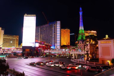 Las Vegas, Nevada - April 13, 2024: Vibrant Night View of Las Vegas Strip with Horseshoe and Eiffel Tower clipart