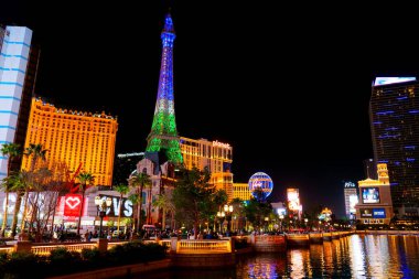 Las Vegas, Nevada - April 13, 2024: Las Vegas Strip at Night with Eiffel Tower and Planet Hollywood clipart