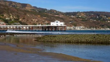 Malibu, California - 29 Kasım 2024 Malibu Rıhtımı Kayalık Sahilinde dalgaları yakalayan sörfçülerle birlikte gösterildi.