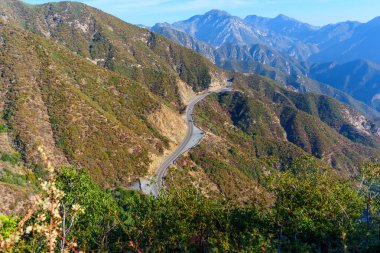 Scenic Winding Highway Through California's Mountain Landscape clipart