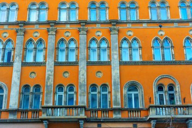 Budapest, Hungary - November 24, 2024: Close-Up of Ornate Orange Facade with Windows in Budapest clipart