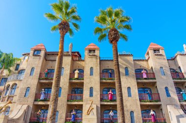 Riverside, California - December 30, 2024: Vibrant Mission Inn Hotel in Riverside with Figurines and Palm Trees clipart