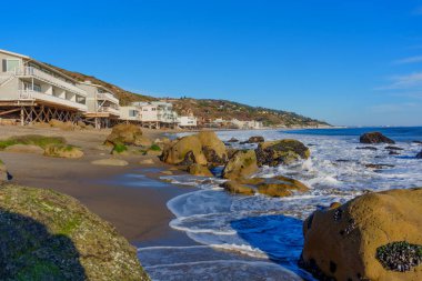 Dalgalar Malibu Sahili 'nde kayalara çarpıyor.