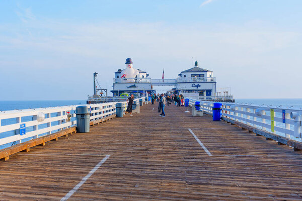 Malibu, California - December 21, 2024: Tourists Enjoy Sunny Day on Malibu Pier, Taking Pictures and Strolling