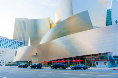 Los Angeles, California - 4 Aralık 2024: Walt Disney Konser Salonu 'nun geniş açılı görüntüsü ikonik tasarımı ve yansıtıcı yüzeyleri sergilenmektedir. Önünde dört araba var..