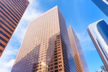Los Angeles, Kaliforniya - 4 Aralık 2024: Los Angeles şehir merkezindeki modern gökdelenlerin dramatik alçak açılı manzarası, One California Plaza, Two California Plaza ve Wells Fargo Center dahil.