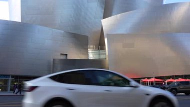 Los Angeles, Kaliforniya - 2 Ocak 2025: Walt Disney Konser Salonu modern mimarisi yürüyen yayalar, hareket eden ve park halindeki arabalar Los Angeles şehir merkezinde