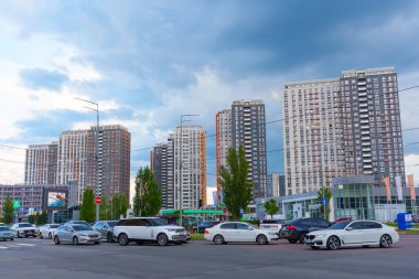 Kyiv, Ukrayna - 19 Mayıs 2025: Kyiv 'deki Residential Complex Seven' ın geniş açılı çekimi, çarpıcı gökyüzü altında modern gökdelenleri ve araçları göstermektedir..
