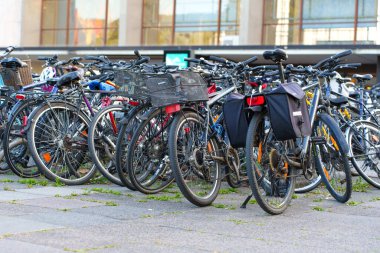 Heidelberg, Almanya - 21 Haziran 2025: Gündüz vakti çeşitli bisikletlerin bulunduğu kalabalık park alanı.