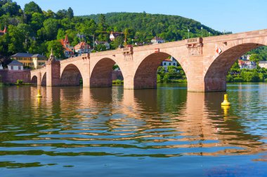 Heidelberg 'deki Eski Köprü' nün geniş açılı görüntüsü Neckar Nehri 'nin sakin sularına yansıyor..