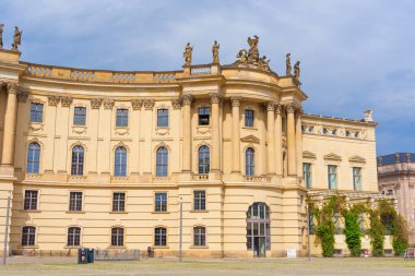 Berlin, Almanya - 1 Haziran 2025: Humboldt Üniversitesi 'nin ana binası neoklasik mimari, karmaşık heykeller ve zarif bir görünüme sahiptir. Aydınlık bir gün yapıyı aydınlatır.