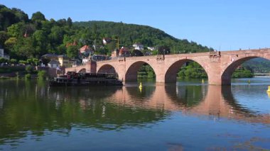 Heidelberg, Almanya - 21 Haziran 2025: Güneşli bir günde altından bir tekne geçen Heidelberg 'deki Eski Köprü manzarası.