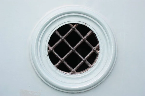 Vintage door observation hatch or peephole close-up, Budapest, Hungary