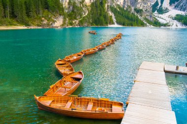 Tahta tekneler ve Dolomitlerle Braies Gölü 'nün göz kamaştırıcı manzarası, İtalya.