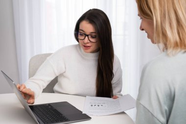 Businesswoman has an appointment with a client and shows documents