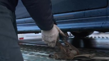 Hands of man fixing trailer on car with closed hitch lock handle. Professional driver prepares transportation for tow carrying closeup