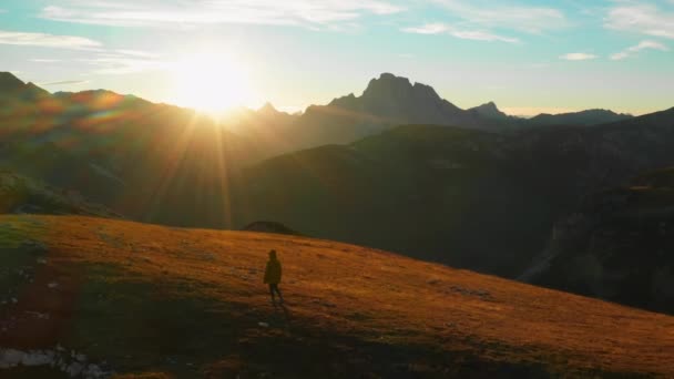 Man Contemplates Bright Sunset Standing Plateau Giant Rocky Mountains Tourist — Video Stock