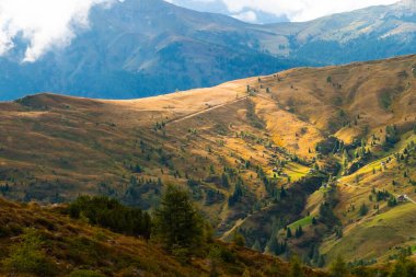 Valley in Dolomites Alps covered with clouds and the Pass Giau. 
