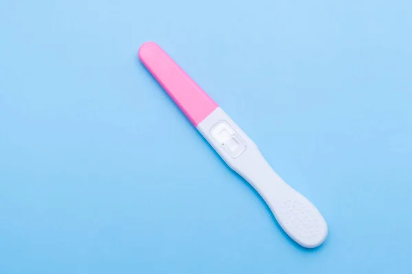 Close up unused pregnancy test on the blue background. Planning of pregnancy