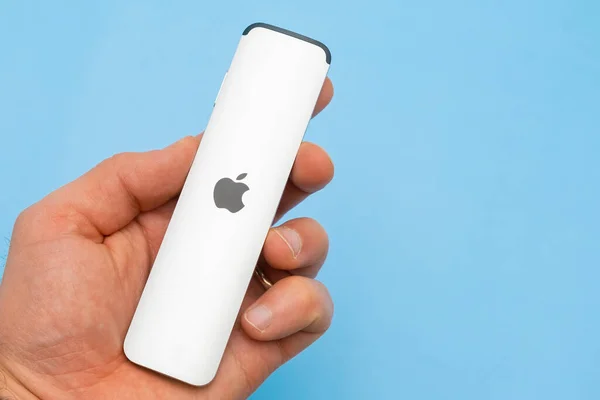 A Siri Remote controller for Apple TV 4K on the blue background with copy space. February 2022, Prague, Czech Republic