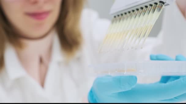 Cientista Concentrado Derrama Substância Amarela Tubos Com Dispensador Pipeta Mulher — Vídeo de Stock