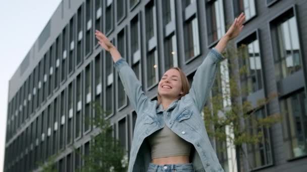 Cheerful Young Blonde Woman Denim Jacket Stretches Arms Front Office — Stock Video