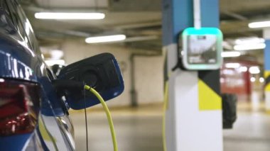 Çevre dostu otomobil yeraltı otoparkında şarj edildi. Şehirlerde hava kirliliği sorunlarını önlemek için sürdürülebilir ulaşım çözümleri kavramı