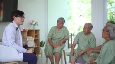 Doctor explaining about medical care and treatment to a group of senior elder patient in hospital ward.