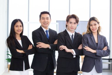 Zeki ve yakışıklı Asyalı iş adamları kendilerini bir arada tutmak iyi takım çalışması, uyumlu ve birlik demektir. İş adamı ve iş kadını konferans odasında el ele tutuşuyorlar..