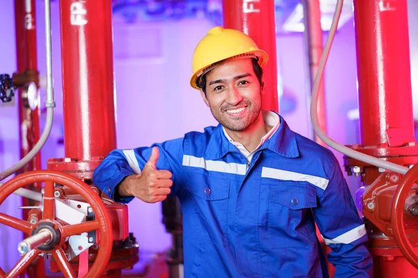 Professional male Asian system engineer smiling and looking at camera, professional foreman posing for photography. Asian male engineer making arms crossed and smiling to camera.