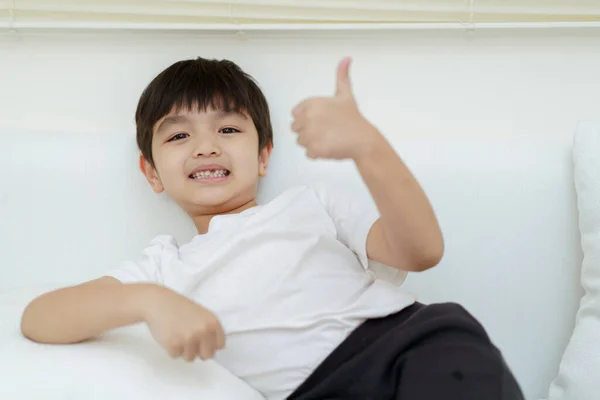 Happy Cheerful Asian Little Young Boy Sits Sofa Plays Camera — Stock Photo, Image