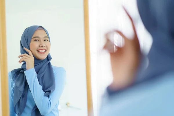 女性のイスラム教徒の人々の肖像画 化粧品を適用し 彼女の顔をブラッシング美しいアジアのイスラム教徒の女性の現代的なライフスタイル 現代のイスラム教徒のライフスタイルコンセプト — ストック写真
