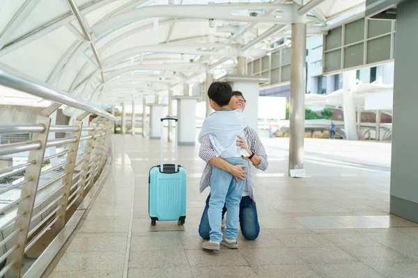 Stock image Happy cheerful Asian little boy running to his father at the railway or sky train station after his father returned from the traveling trip. Happy Asian family father and son concept.