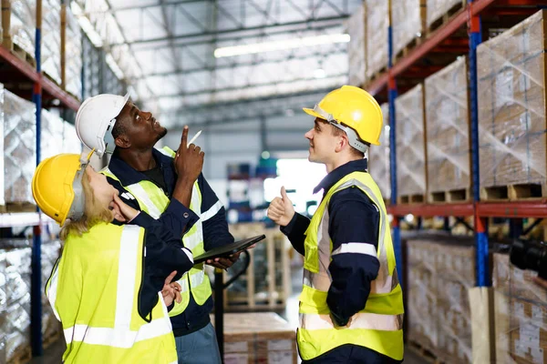 stock image Diversity ethnicity of warehouse staff or engineer making a discussion together before start working, team of engineer in factory making a morning brief before working.