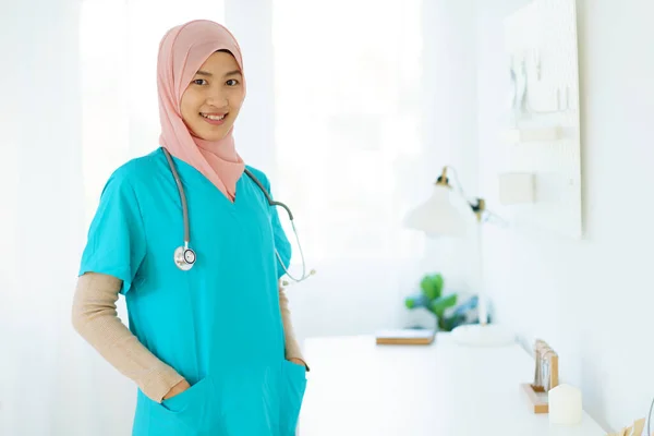 Asian female muslim doctor showing a doctor stethoscope to camera close up with copyspace. An expertise or occupation in modern muslim people concept.