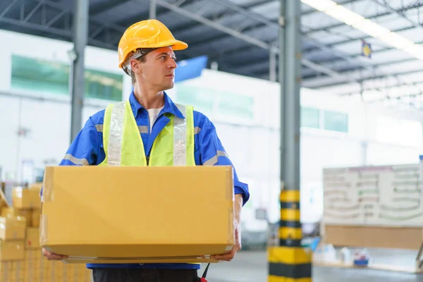 Professional caucasian white male warehouse worker working in the factory or warehouse, caucasian male warehouse employee packing and showing parcel package.