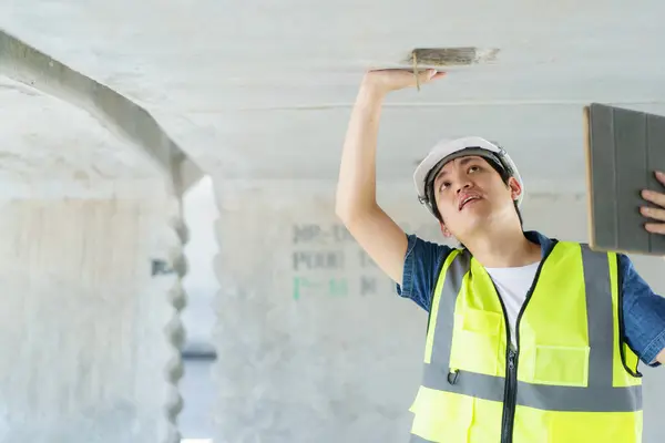 Professional senior Asian civil engineer working at the heavy infrastructure construction site, civil engineer - foreman inspecting the segmentation construction bridge.
