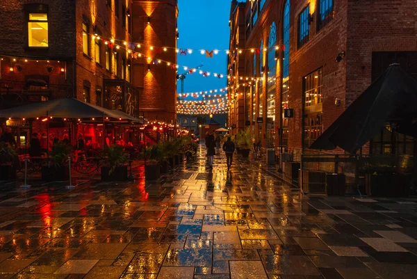 stock image Illuminated Akker Brygge, a modern district in Oslo city center at night and in the rain, Norway