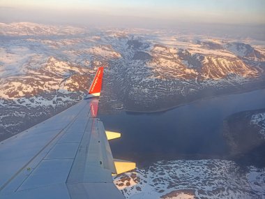 A view from a plane of winter nature around Alta, Norway clipart