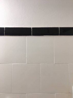 black and white tiles of a bathroom wall