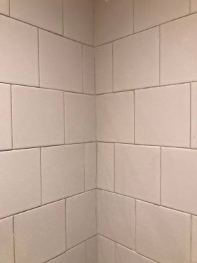 Detail of old white tiles on the walls of a bathroom