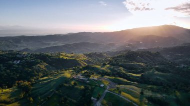 mountain view in the mountains, the sun shines through the fog.
