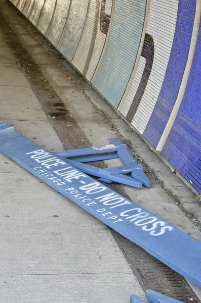 Broken police barrier on a sidewalk