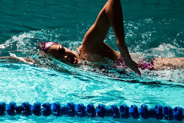 Young woman swimmer training in the pool. Professional swimmer i
