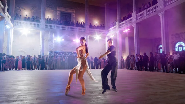 Couple dancers  perform latin dance on large professional stage.