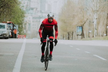 Şehirde bisiklete binen genç adam, gündüz manzaralı. 