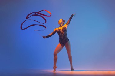 Ritmik jimnastik iş başında. Ritmik jimnastikçi kadın stüdyoda dans ediyor..