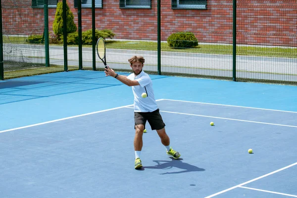 Tennis player training on a professional tennis court